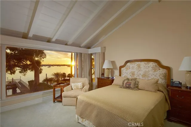 a spacious bedroom with a bed and large glass window