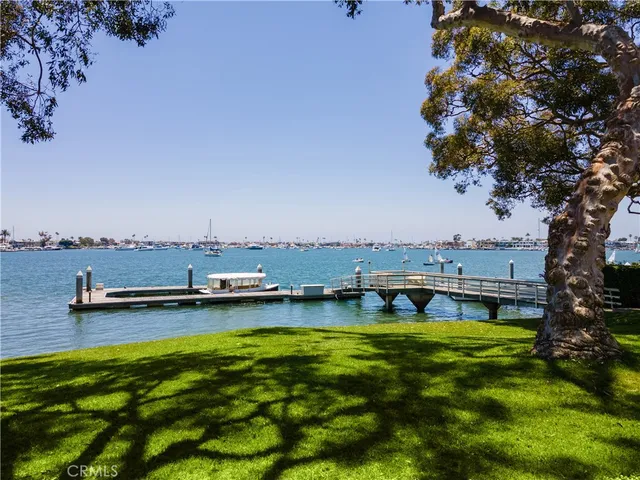 a view of a swimming pool with lawn chairs and a yard