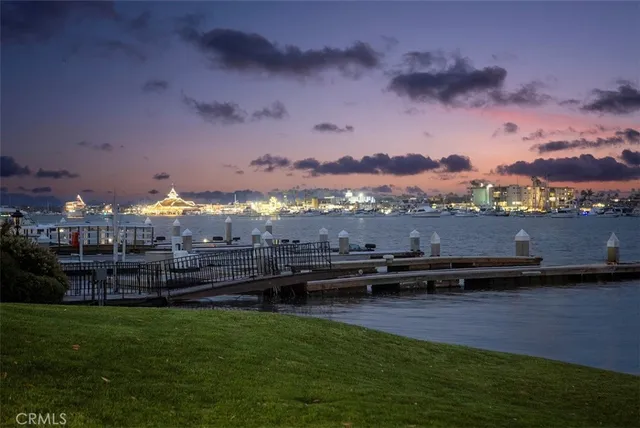 a view of a city with lots of residential buildings ocean and mountain view in back