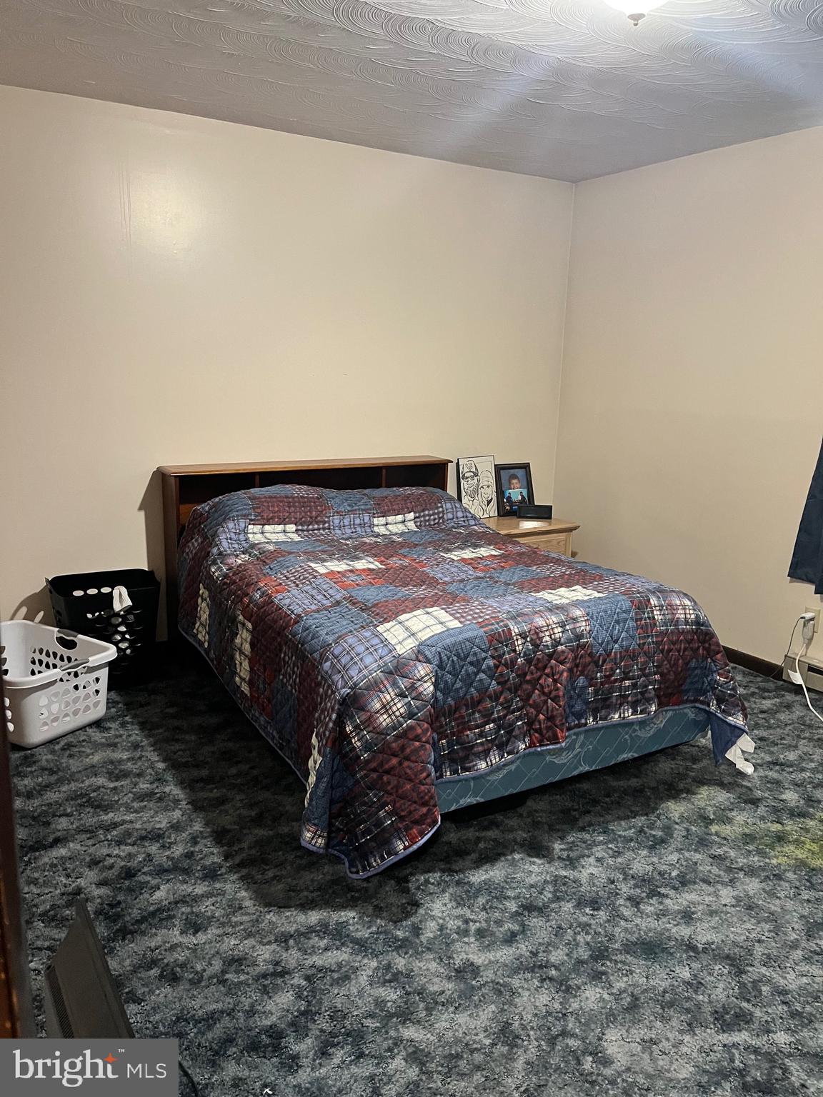 2166 Country Road Maysville, WV 26833 - Photo 20 of 54 a bed sitting in a bedroom next to a white wall