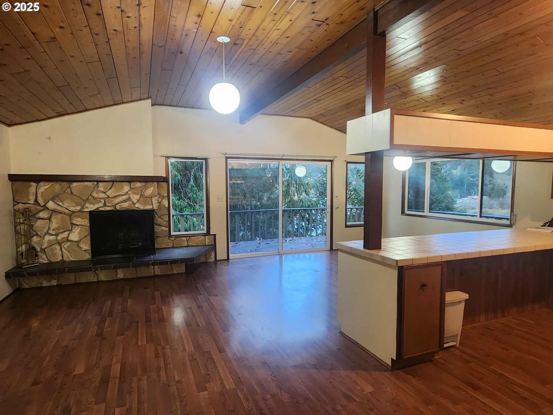 96015 Sun Lake Lane Lakeside, OR 97449 - Photo 27 of 46 a living room with hard wood floors and a fireplace