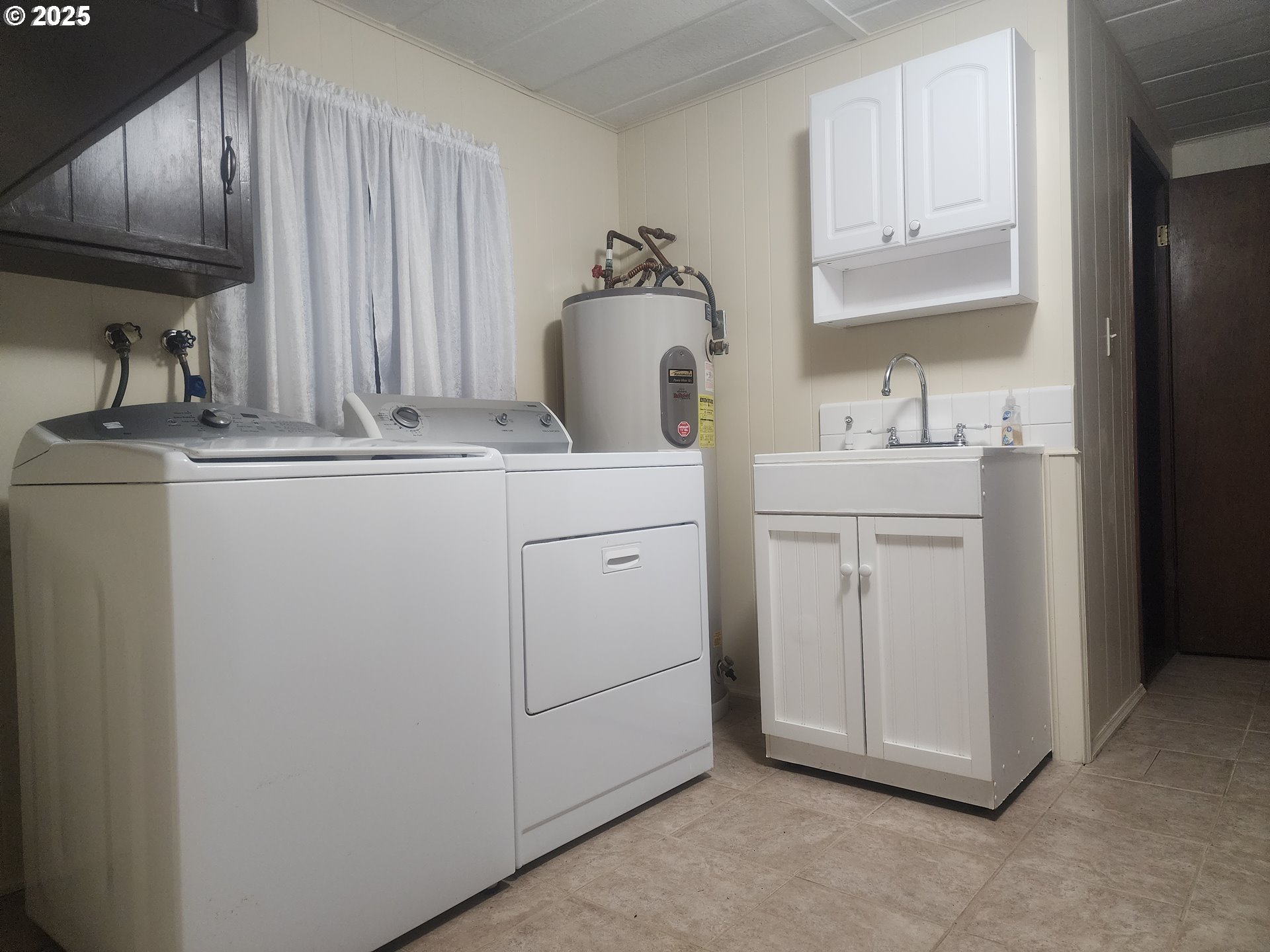 96015 Sun Lake Lane Lakeside, OR 97449 - Photo 32 of 46 a kitchen with white cabinets and sink