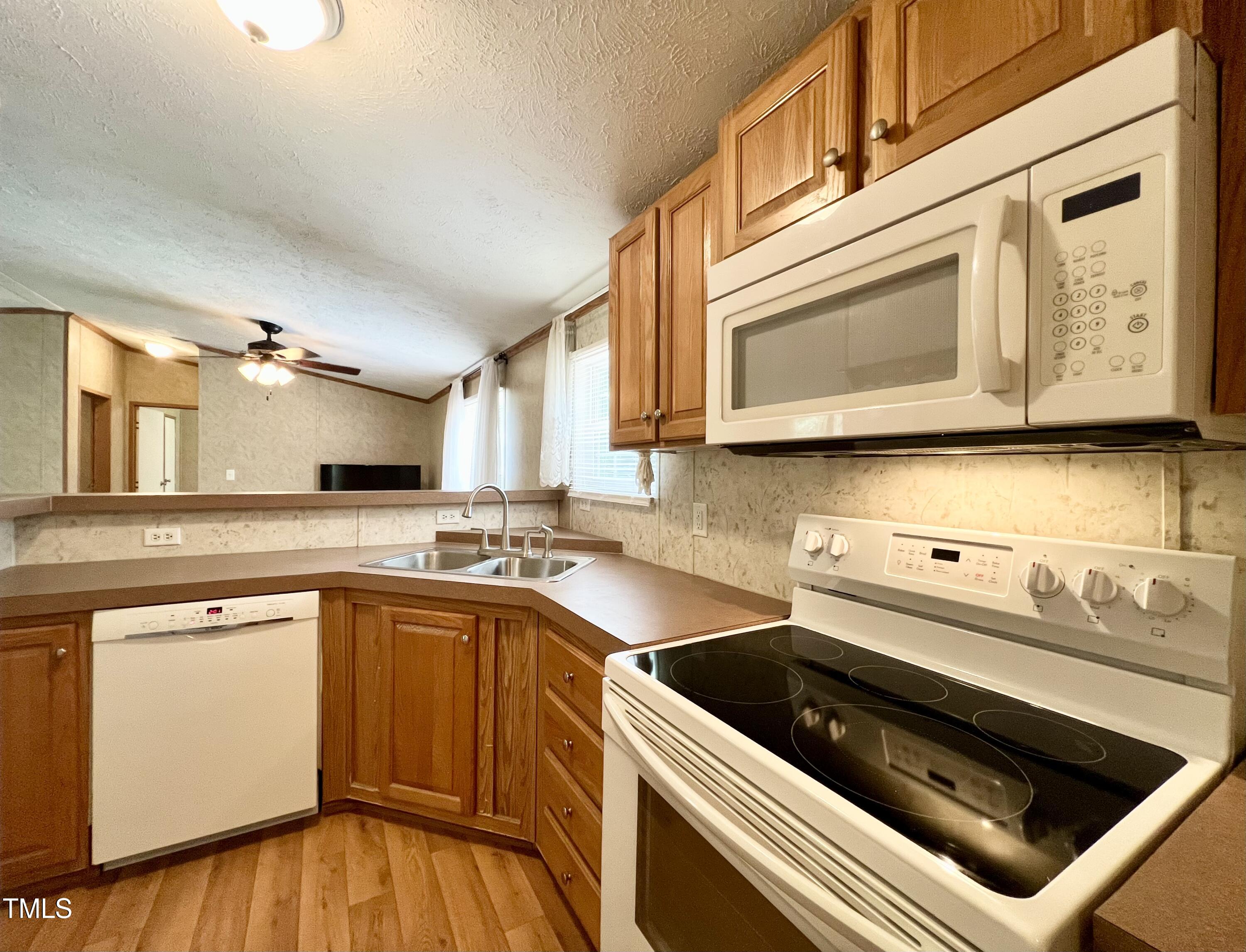 665 Christys Way Roxboro, NC 27574 - Photo 11 of 57 a kitchen with stainless steel appliances granite countertop a sink stove and microwave