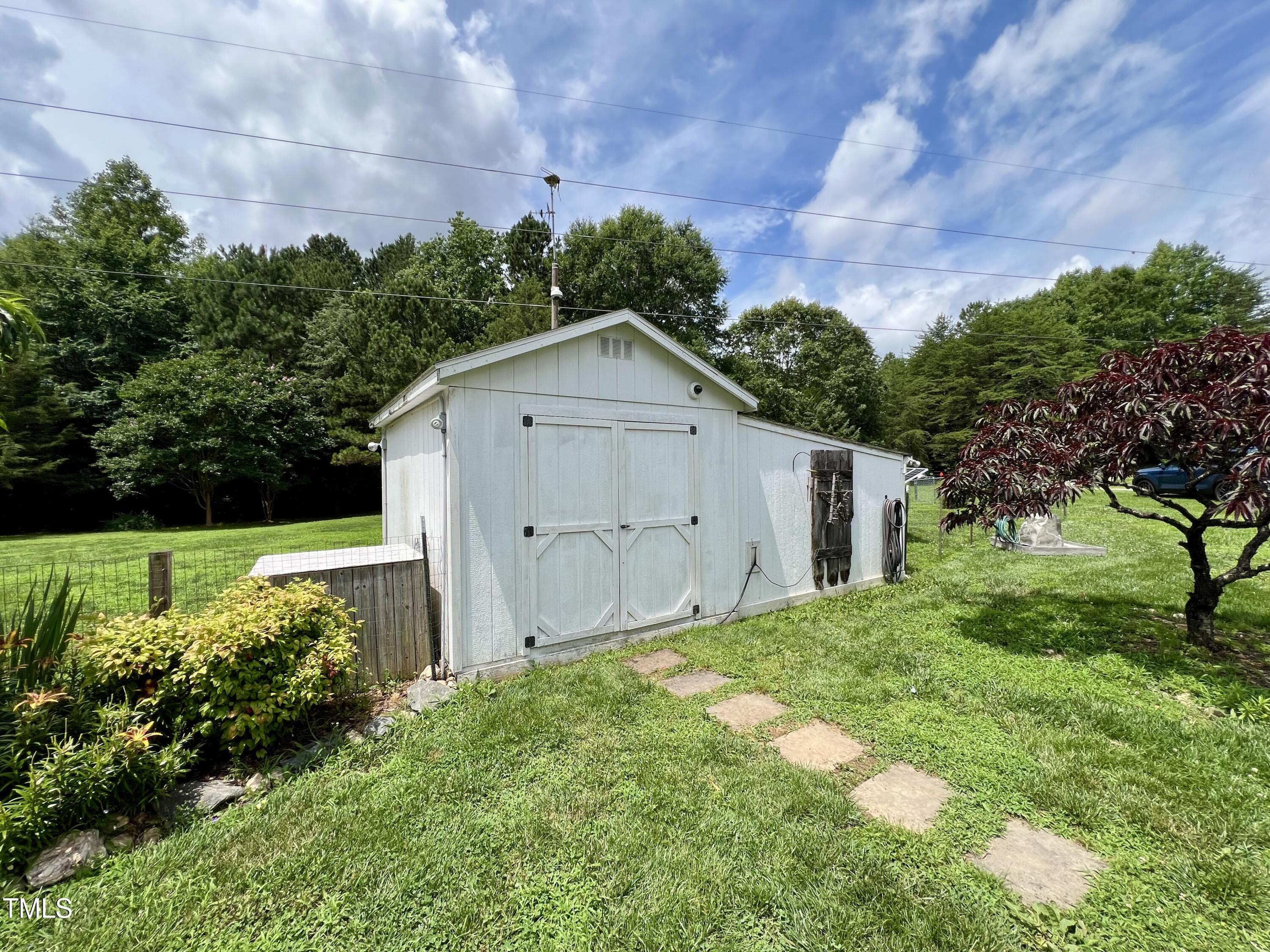 665 Christys Way Roxboro, NC 27574 - Photo 40 of 57 a view of a house with a yard and potted plants