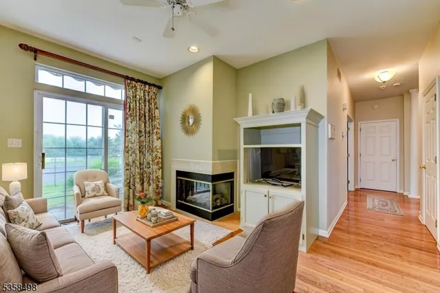 a living room with furniture flat screen tv and a fireplace