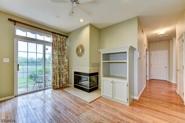 a view of a livingroom with a fireplace and wooden floor
