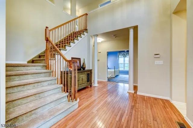 a view of entryway and hall with wooden floor