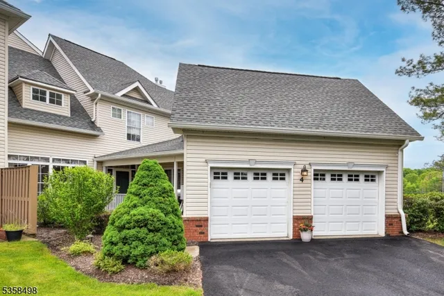 a view of a white house with many windows
