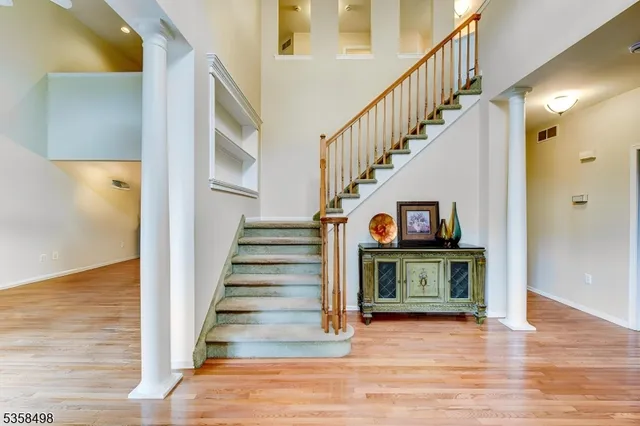 a living room with wooden floor and a fireplace
