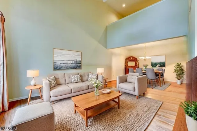 a living room with furniture a rug and a table