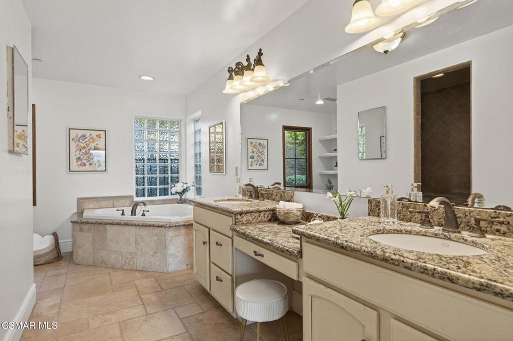 1560 Goodenough Road Fillmore, CA 93015 - Photo 32 of 76 a bathroom with a granite countertop sink a large mirror and a bathtub