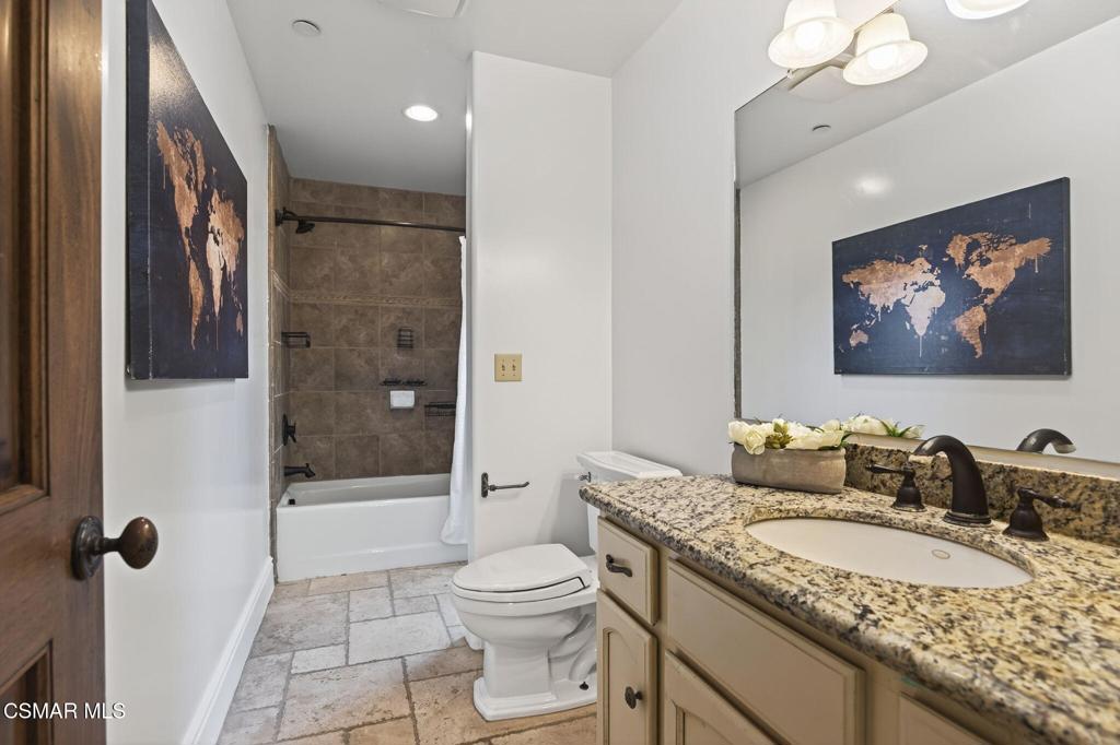 1560 Goodenough Road Fillmore, CA 93015 - Photo 37 of 76 a bathroom with a granite countertop sink a toilet a mirror a vanity and shower
