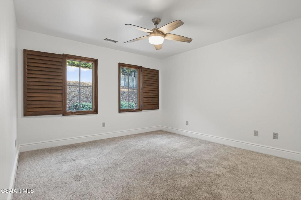 1560 Goodenough Road Fillmore, CA 93015 - Photo 39 of 76 an empty room with windows and chandelier fan