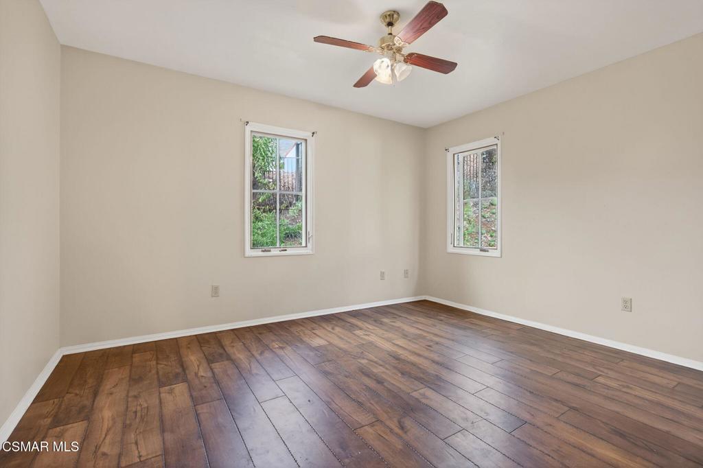1560 Goodenough Road Fillmore, CA 93015 - Photo 49 of 76 a view of empty room with wooden floor and fan