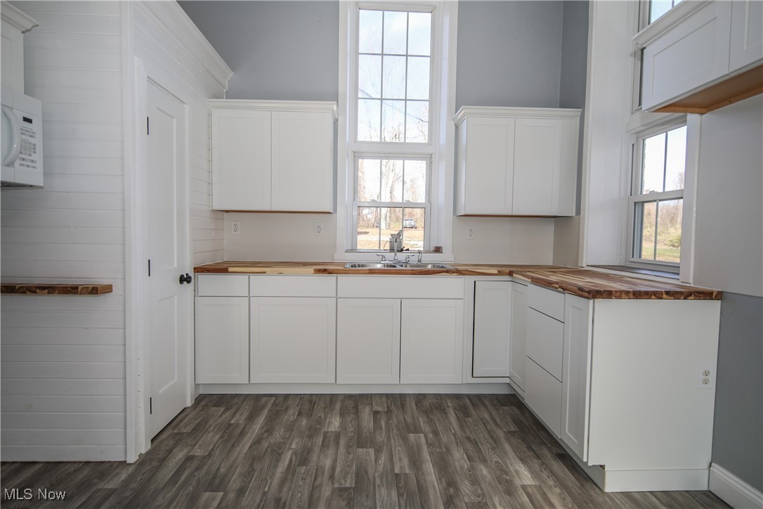 67480 Barnesville Hendrysburg Road Barnesville, OH 43713 - Photo 8 of 16 Kitchen with dark wood-type flooring, butcher block countertops, and white cabinetry