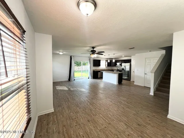a view of a kitchen with a sink cabinets and a window