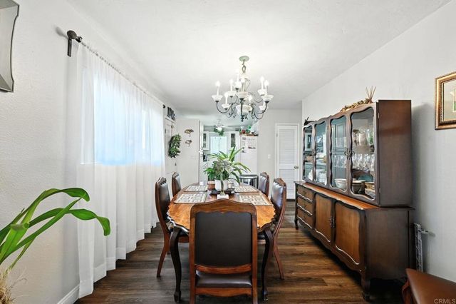 a bedroom with bed and wooden floor