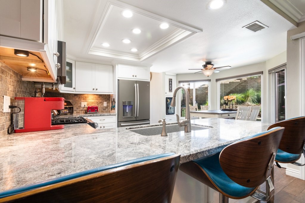 8251 Bent Tree Lane Riverside, CA 92509 - Photo 15 of 57 Granite counter with seating in the kitchen