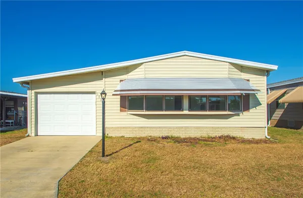 a view of a house with a backyard