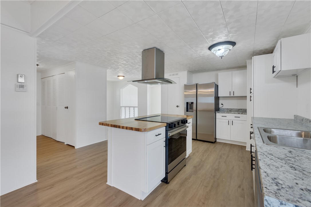 908 Oleander Circle Sebastian, FL 32976 - Photo 12 of 36 a kitchen with stainless steel appliances granite countertop a stove and a refrigerator