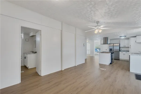 a view of a kitchen with a sink and a refrigerator