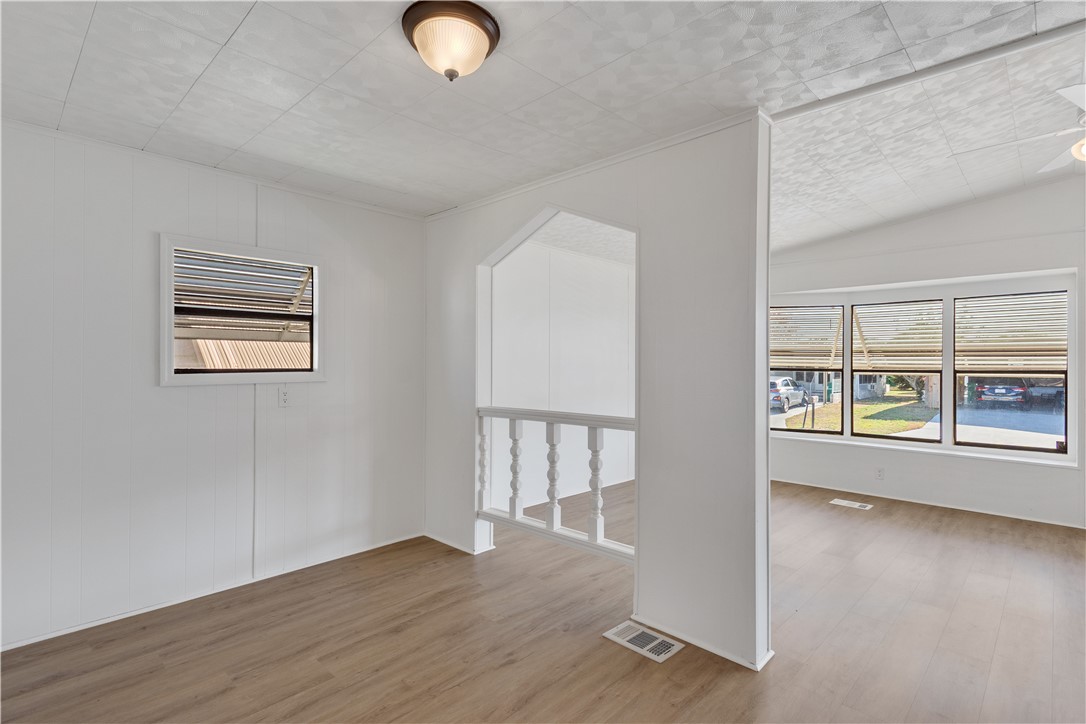 908 Oleander Circle Sebastian, FL 32976 - Photo 14 of 36 an empty room with wooden floor and windows