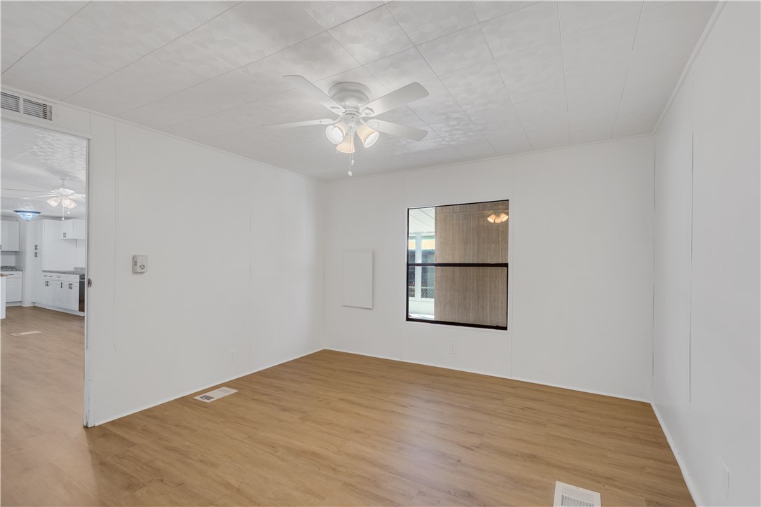 908 Oleander Circle Sebastian, FL 32976 - Photo 16 of 36 an empty room with windows and fan