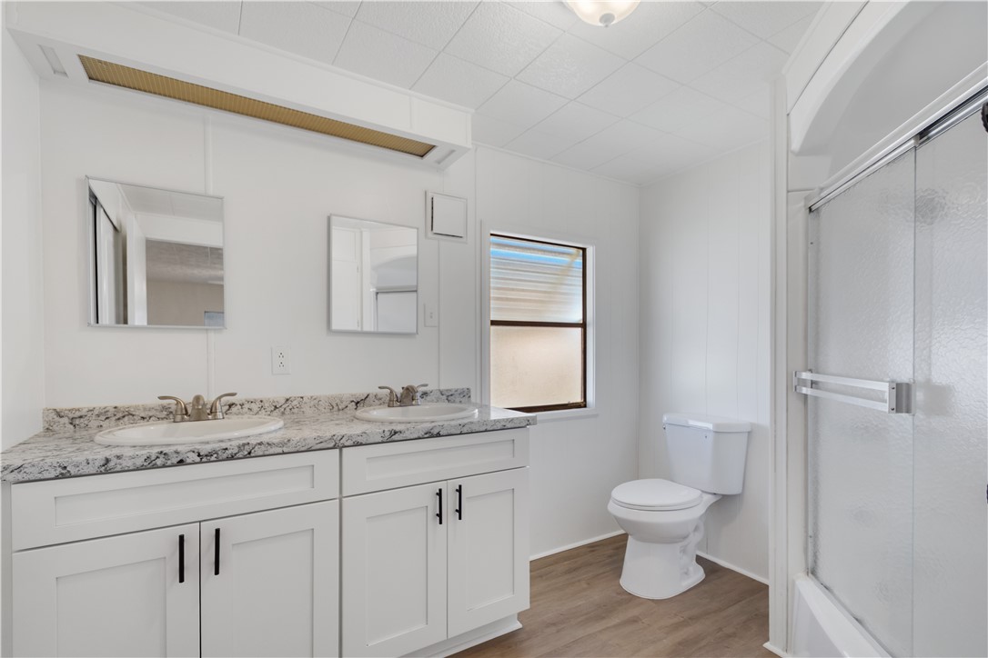 908 Oleander Circle Sebastian, FL 32976 - Photo 17 of 36 a bathroom with a toilet sink and mirror