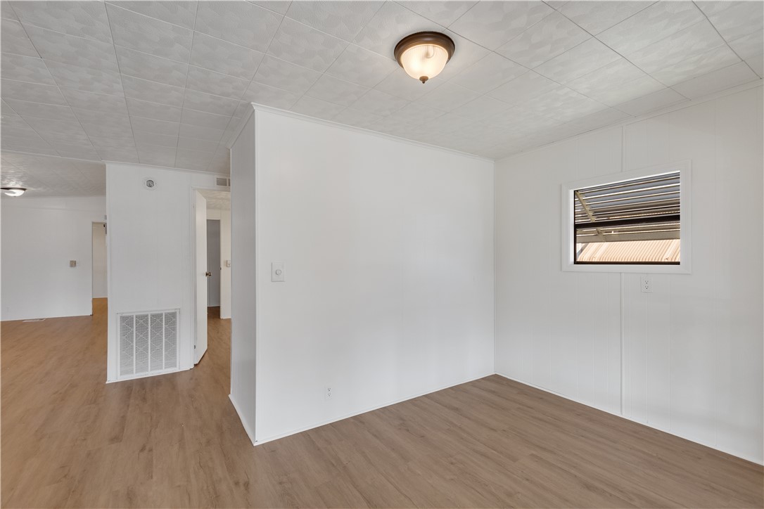 908 Oleander Circle Sebastian, FL 32976 - Photo 8 of 36 an empty room with wooden floor and windows