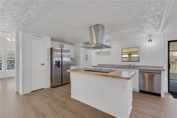 a kitchen with stainless steel appliances granite countertop a stove and a refrigerator