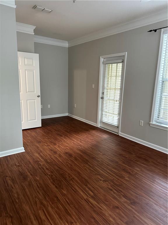 5208 Westchester Ridge Northeast Atlanta, GA 30329 - Photo 16 of 32 an empty room with wooden floor and windows
