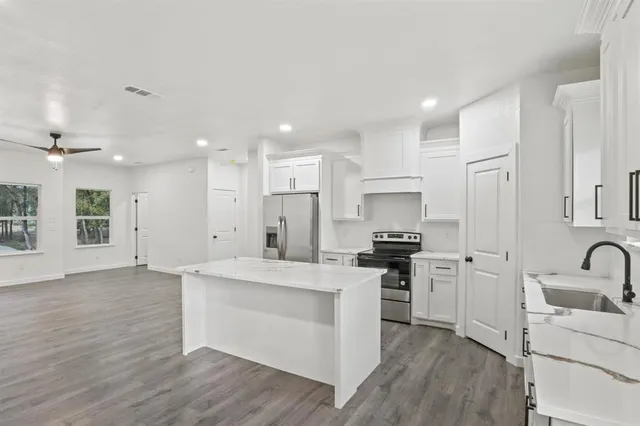 a kitchen with a sink stove and cabinets