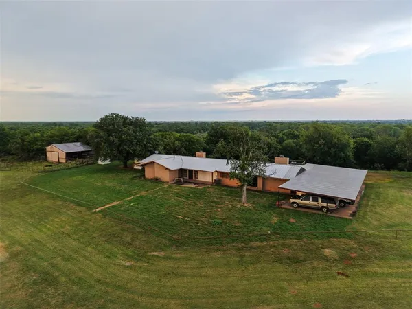 a view of a chairs and table on the garden