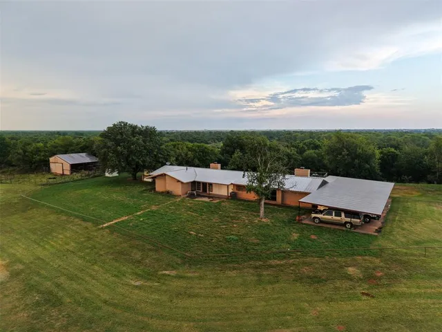 a view of a chairs and table on the garden