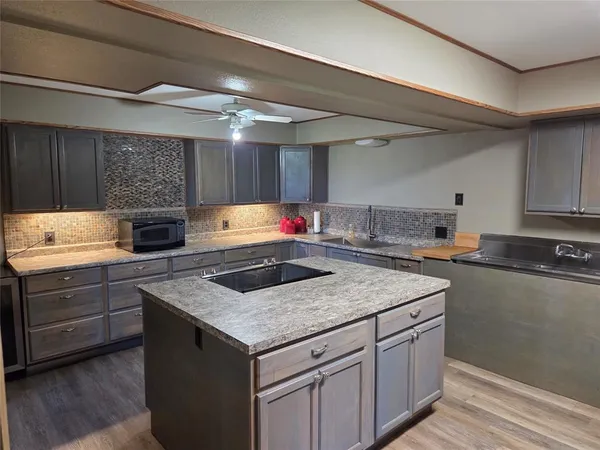 a kitchen with stainless steel appliances granite countertop a sink stove and cabinets
