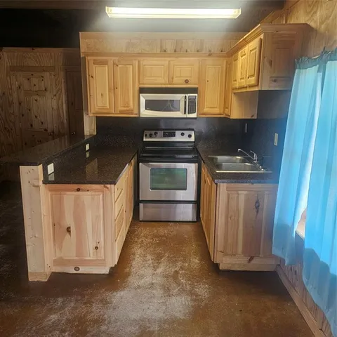 a kitchen with a stove and a sink