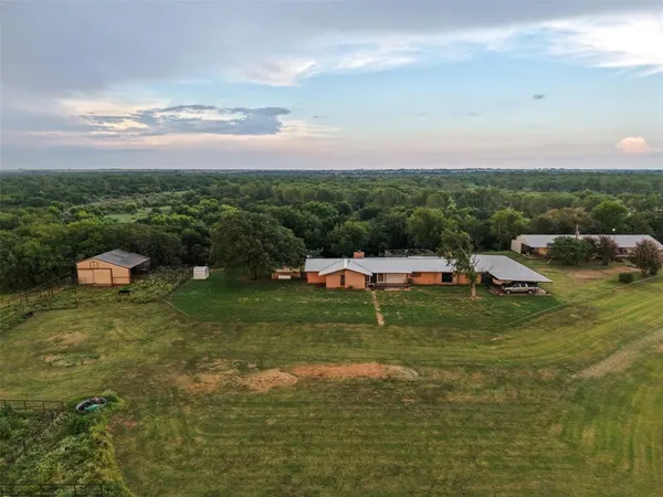 a backyard of a house with table and chairs