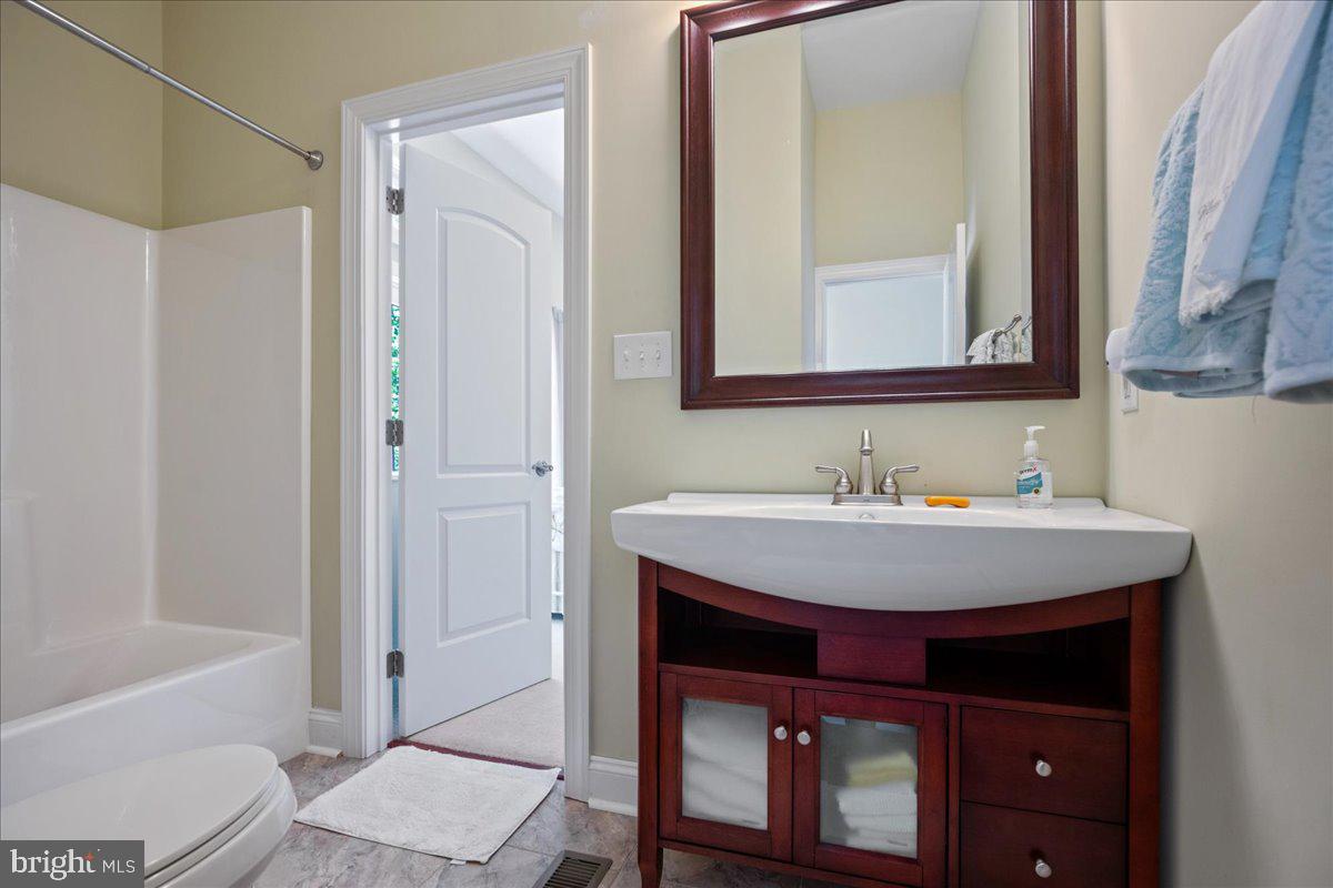 45216 Clarkes Landing Road Hollywood, MD 20636 - Photo 38 of 81 a bathroom with a sink a toilet and shower