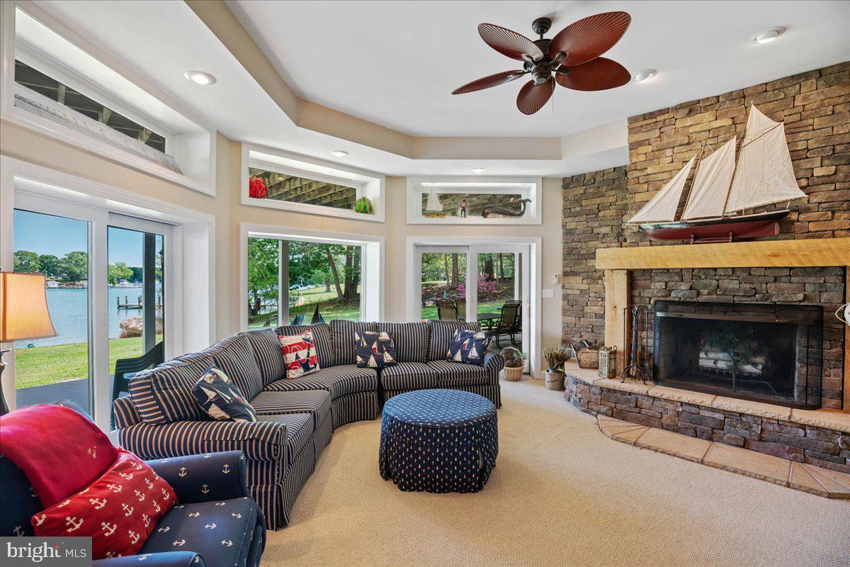 45216 Clarkes Landing Road Hollywood, MD 20636 - Photo 45 of 81 a living room with furniture a large window and a fireplace