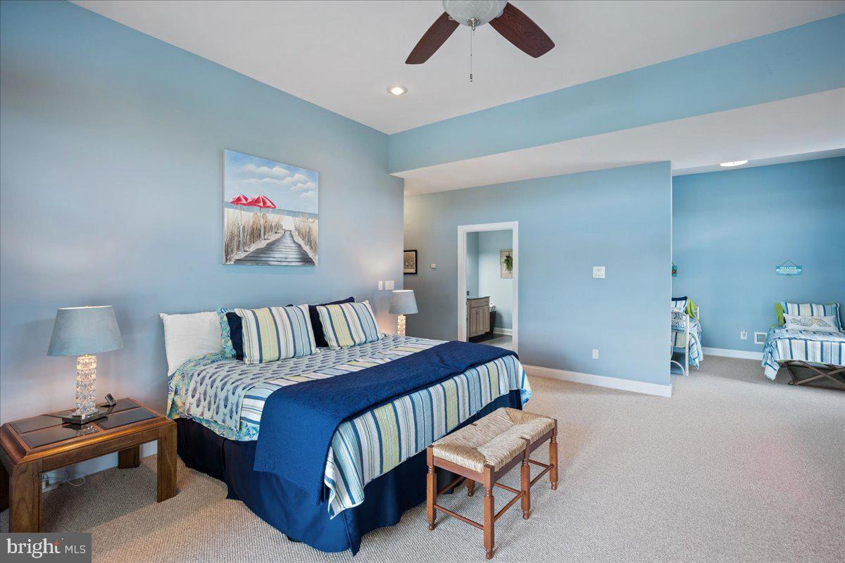 45216 Clarkes Landing Road Hollywood, MD 20636 - Photo 54 of 81 a spacious bedroom with a bed and a chandelier
