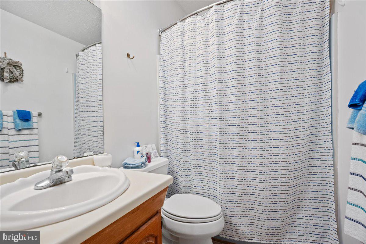 45216 Clarkes Landing Road Hollywood, MD 20636 - Photo 74 of 81 a bathroom with a sink a toilet and mirror