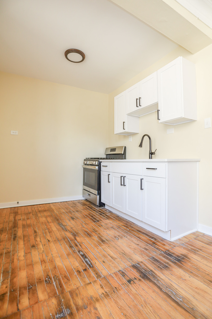 4019 West School Street, Unit 2E Chicago, IL 60641 - Photo 3 of 8 a view of a kitchen with a sink