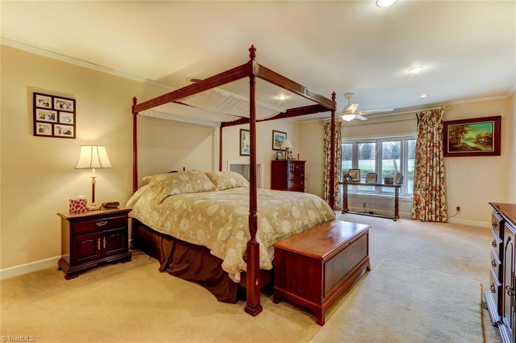647 Simpson-Calhoun Road Greensboro, NC 27455 - Photo 11 of 30 The large master bedroom has double closets and a large window overlooking the front pasture.