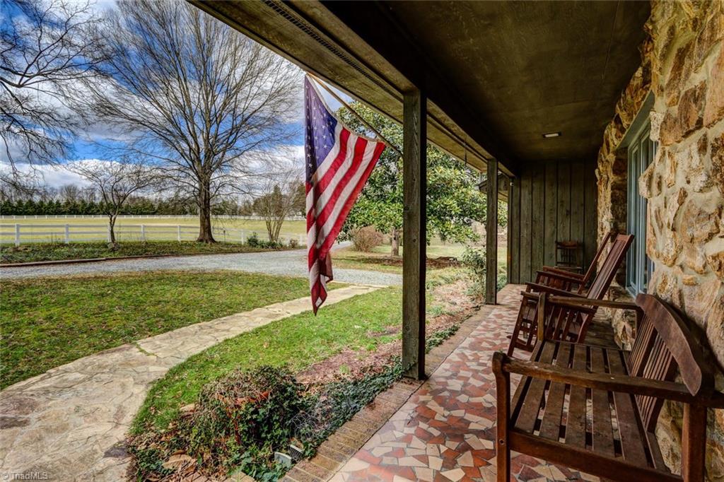 The house sits off the road, making the front porch perfect for sitting and sipping while walking your horses.