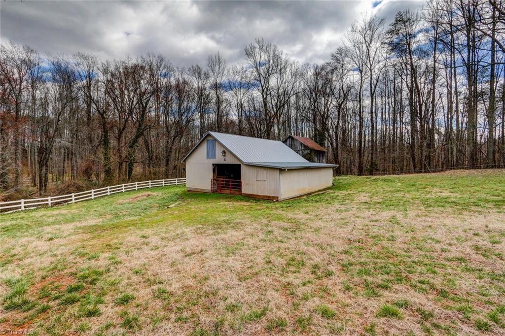 647 Simpson-Calhoun Road Greensboro, NC 27455 - Photo 21 of 30 4 stall barn with locking feed/tack room. Also room for equipment or expansion. Hay storage room above.