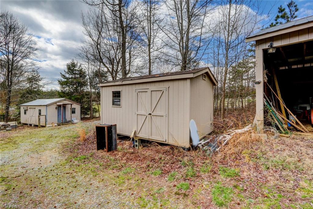 647 Simpson-Calhoun Road Greensboro, NC 27455 - Photo 23 of 30 Several of the outbuildings included.