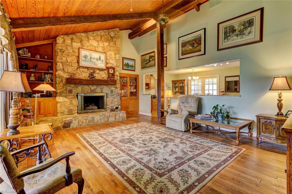The original section features hand hewn beams and a floor to ceiling stone fireplace.
