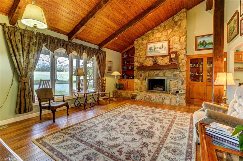 Another view of this large gathering room.  Hardwood flooring, built in shelving and tongue and groove ceiling.