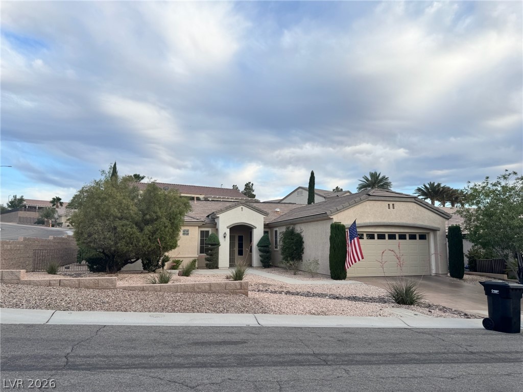 This desert oasis features a classic tiled roof and attached garage, offering comfortable living.