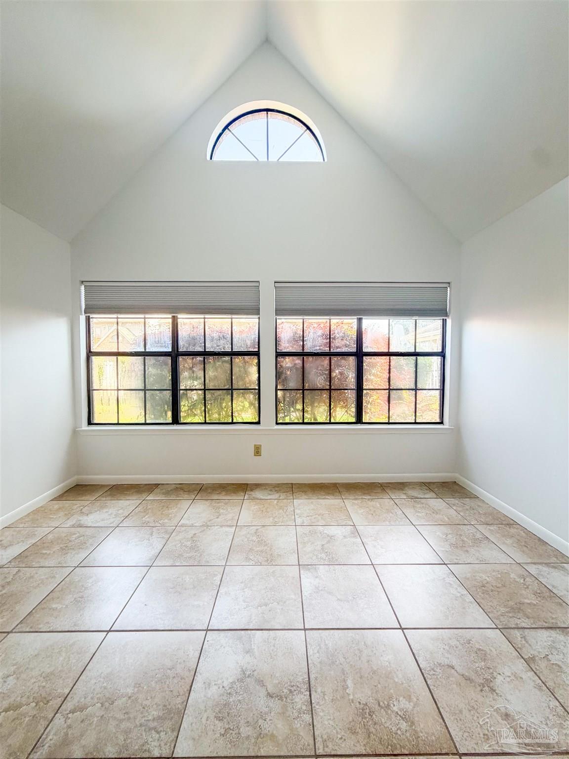 7150 Plantation Road, Unit 312 Pensacola, FL 32504 - Photo 4 of 14 a view of an empty room with a window